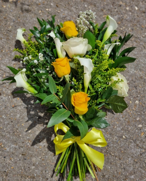 Classic sheaf to include Calla Lily and Roses with foliage and white and yellow fillers.  By Blooms and Candy Florist in South London