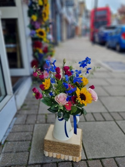 Metal jug with mixed fresh flowers made by florist in Bromley, Kent