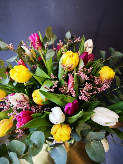 Bright tulips with eucalyptus in 20cm milk vase arranged by local florist in Hayes, Bromley BR