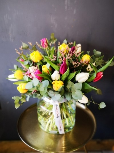 Bright tulips with eucalyptus in 20cm milk vase arranged by local florist in Hayes, Bromley BR