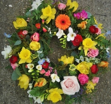 spring funeral wreath to include daffodils handmade by florist in Bromley and Beckenham