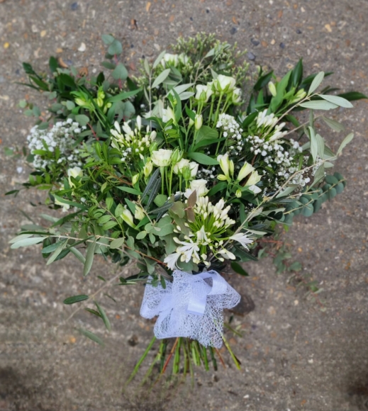 natural mix of foliagies with wax ,  freesias, small roses and gypsophilium by Blooms and Candy Florist