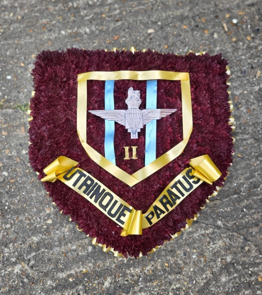funeral flowers badge or shield by Blooms and Candy Florist
