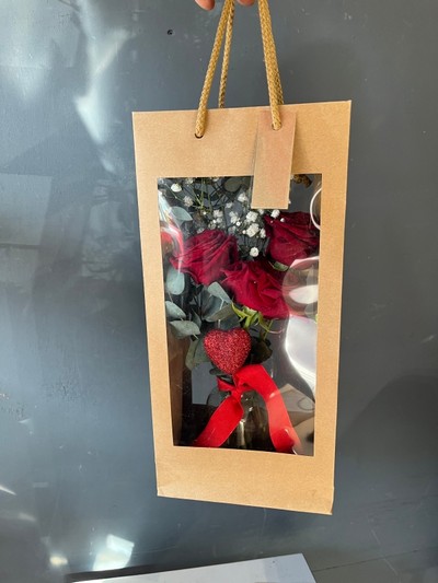 3 red roses and a heart in small vase presented in kraft gift bag.  Lovely additional gift for a young lady or as a token gift.By florist in Hayes, Bromley for delivery on Valentine’s Day 2023