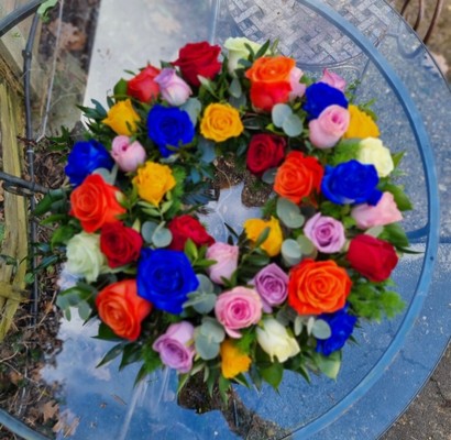 Mixed roses funeral wreath with mixed foliages. Made by local funeral florist in Bromley, Beckenham, Croydon, Chislehurst, Orpington, Biggin Hill