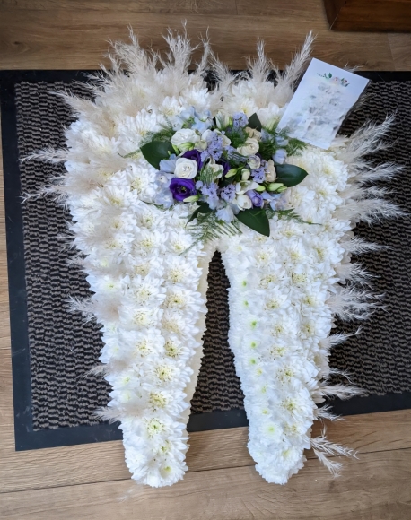 Funeral flowers wings by Blooms and Candy Florist