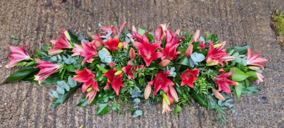mixed asiatic lilies coffin spray made by Blooms and Candy florist