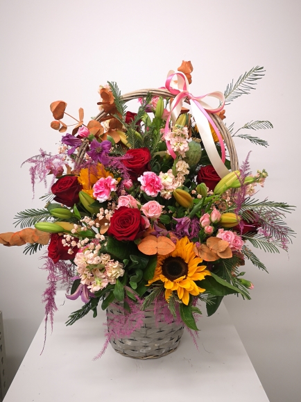 Lovely large wicker basket with mixed  flowers and fillers arranged by florist in Bromley for same day delivery in BR