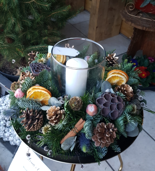 Christmas table wreath with pillar candle inside a glass vase hand made by florist in Hayes, Bromley.