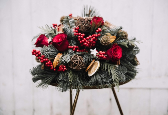 Fresh flowers Christmas table posy with red roses, ilex and winter foliages and decorations for delivery in BR postcodes in the UK