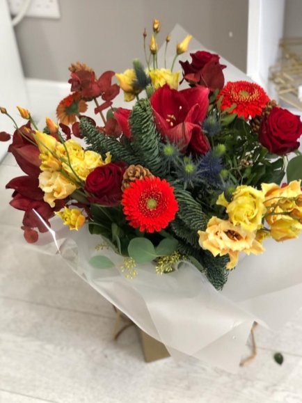 Christmas bouquet with red amarylis, blue pine, orange lisanthius handmade by local florist in Bromley available for same day delivery in BR