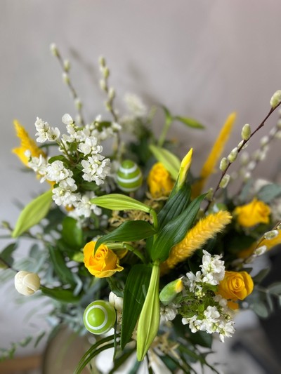 Fresh flowers 30cm tall green glass vase arrangement to include Longi Lilly, Pussy Willow, blossoms, yellow roses, white and yellow tulips and dry elements.  ​​​​​​​Perfect Easter gift. Made by florist in Bromley 