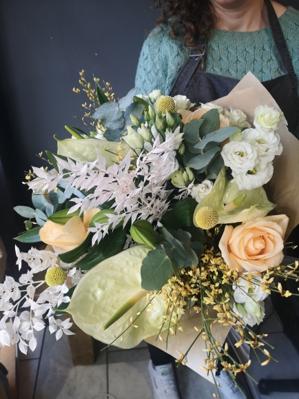 Stunning white and cream hand tie to include anthurium, white ruckus, roses, forsythia, craspedia, eucalyptus, lysanthius for same day delivery in Bromley and Beckenham