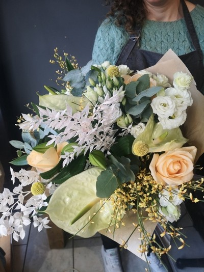 Stunning white and cream hand tie to include anthurium, white ruckus, roses, forsythia, craspedia, eucalyptus, lysanthius for same day delivery in Bromley and Beckenham