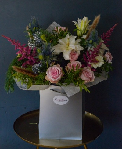 Fun & Frosty Hand-tied Bouquet to include white lily, pink roses, thistle, eucalyptus, astilbe, daisies, grasses, cones handmade by florist in Hayes, Bromley, UK.