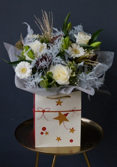Let it Snow Hand-tied Bouquet to include white daisies, roses, lily, scabiosa, natural grasses, silver fern, pines and Christmas foliage handmade by florist in \hayes, Bromley, UK.
