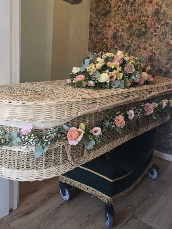 Silver eternity funeral coffin spray with blush pink roses, lisianthus, spray roses and Gypsophilium finished with silver eucalyptus and acacia