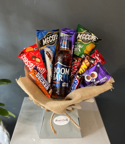 Mix of snacks with craft beer presented in a bouquet, gift wrapped.  bouquet to include:  craft beer, cadbury chocolate bar, kit kat bar, twix bar, snickers bar, random 2 packs of Crisps McCoys, maltesers, lion bar, Kinder Bueno bar, button Cadbury pack, double decker bar. Made by florist in Hayes, Bromley fot sand day delivery in Bromley, Beckenham, Croydon, Shirley, West Wickham, Orpington, Biggin Hill, New Addington