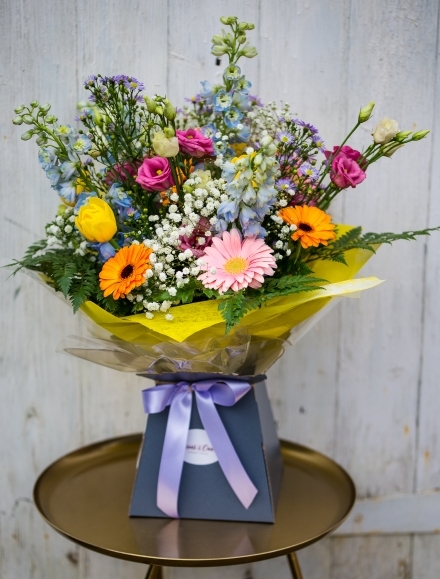 Garden mix bouquet to include gypsophilium, delphiniums, daisies, craspedia, nice foliage arranged by Bromley florist