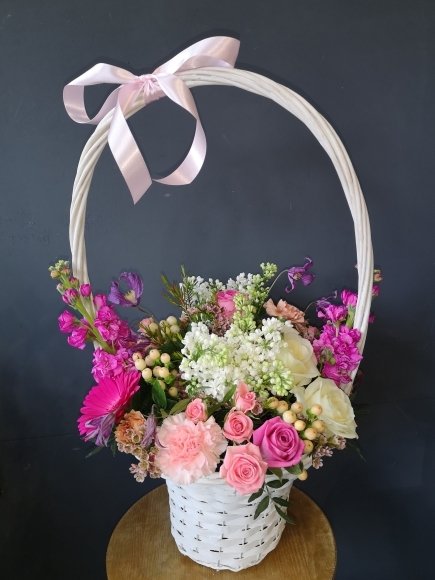 sweet white wash basket arrangement with mix of pinks and whites flowers arranged by local florist in BROMLEY