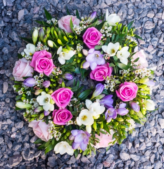 white freesias and roses funeral wreath