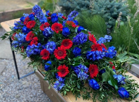 blue and red cofin spray for Crystal Palace fan from Blooms and Candy Florist in Hayes for free delivery in Bromley, Croydon, Croydon Crematorium, Heither Crematorium, Beckenham Crematorium, Lewisham Crematorium