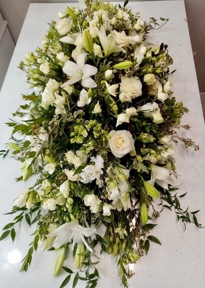 all white coffin spray made by florist in Bromley