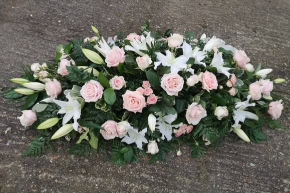 Rose and Lily Coffin Spray made by funeral florist in Bromley