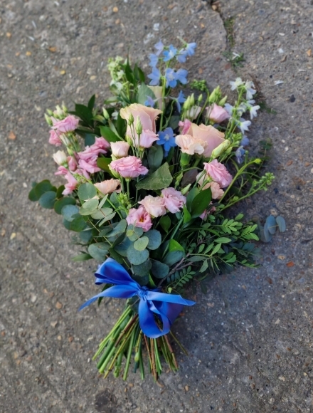 Lovely light blue & soft pinks sheaf to include Delphiniums and Roses by Blooms and Candy Funeral Florist Bromley