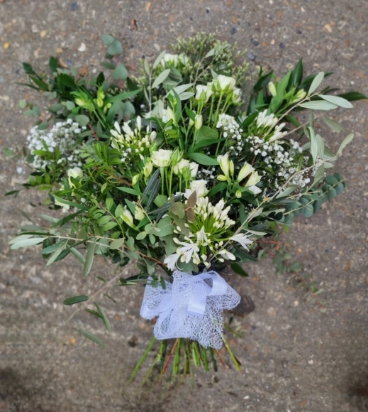natural mix of foliagies with wax ,  freesias, small roses and gypsophilium by Blooms and Candy Florist
