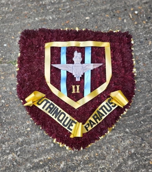 funeral flowers badge or shield by Blooms and Candy Florist