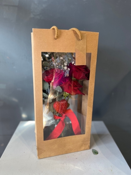 3 red roses and a heart in small vase presented in kraft gift bag.  Lovely additional gift for a young lady or as a token gift.By florist in Hayes, Bromley for delivery on Valentine’s Day 2023