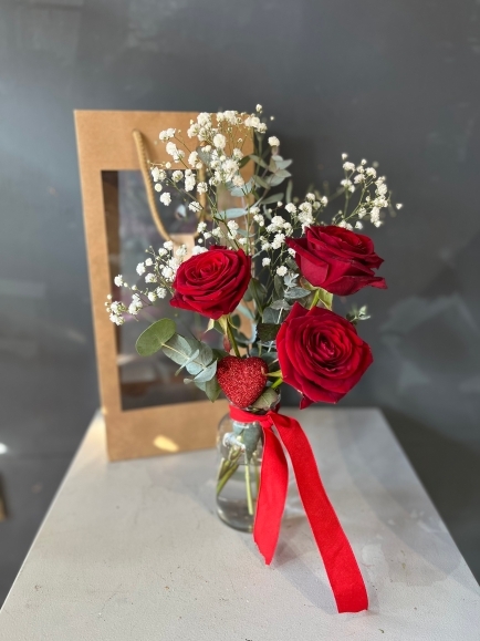 3 red roses and a heart in small vase presented in kraft gift bag.  Lovely additional gift for a young lady or as a token gift.By florist in Hayes, Bromley for delivery on Valentine’s Day 2023