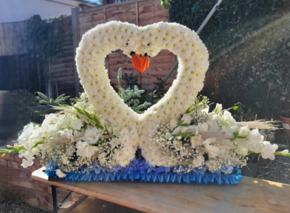 funeral flowers swan design by Blooms and Candy Florist