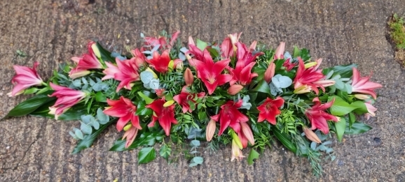 mixed asiatic lilies coffin spray made by Blooms and Candy florist