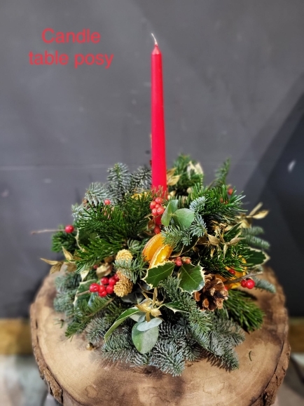 Classic round posy 10inch with winter foliages, holly, berries, pines and oranges with a single candle. Lovely Christmas token. Made by local florist near me in Bromley, Beckenham, Croydon, West Wickham, Elmers End, Biggin Hill, Petts Wood, Chislehurst, 