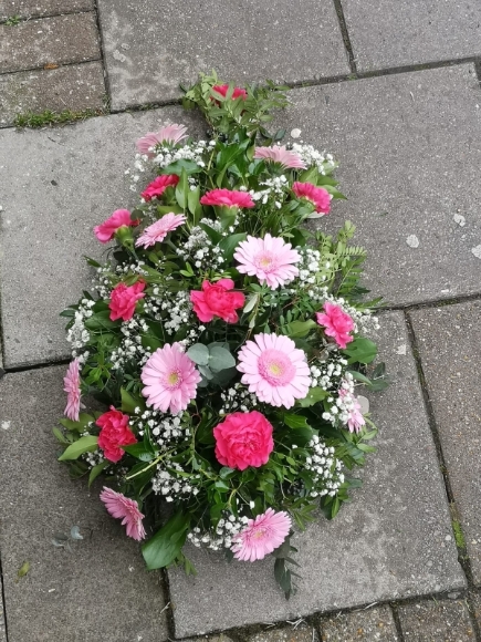 Classic carnations and daisies funeral spray in the shape of teardrop made by florist near me in Bromley, Kent