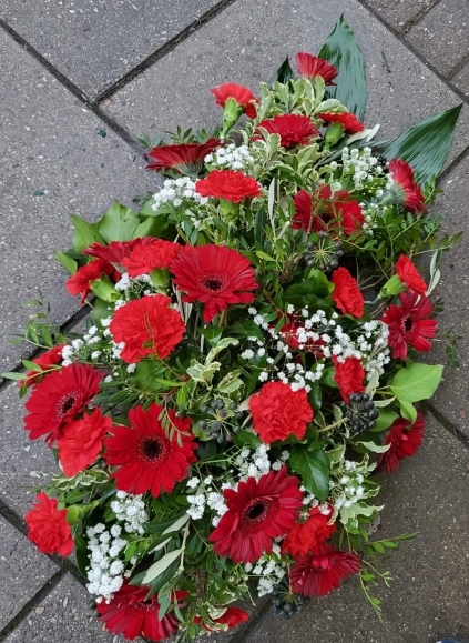Classic carnations and daisies funeral spray in the shape of teardrop made by florist near me in Bromley, Kent