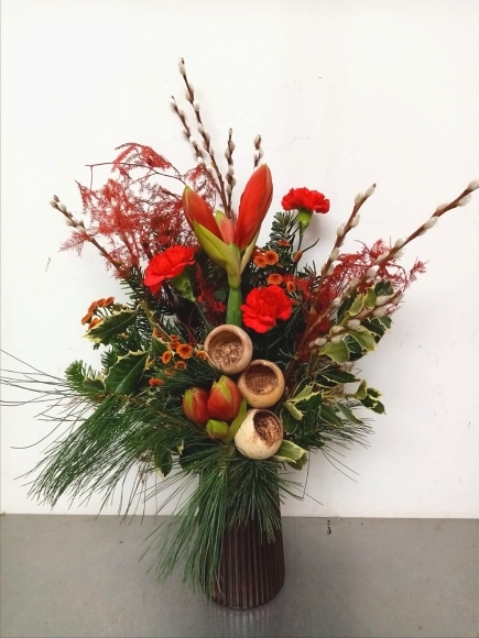 Christmas fresh flowers red vase arranged by local florist in Bromley, Kent.