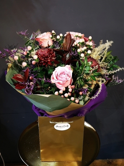 Christmas fresh flowers bouquet to include red blooms and pink roses handmade by florist in Hayes, Bromley.