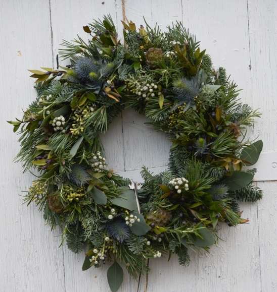 natural botanical Christmas wreath to include evergreen pines, blue spruce, eucylapthus, white dried elements, thisle handmade by florist in Hayes, Bromley, UK avaiable for National Delivery UK