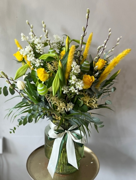 Fresh flowers 30cm tall green glass vase arrangement to include Longi Lilly, Pussy Willow, blossoms, yellow roses, white and yellow tulips and dry elements.  ​​​​​​​Perfect Easter gift. Made by florist in Bromley 