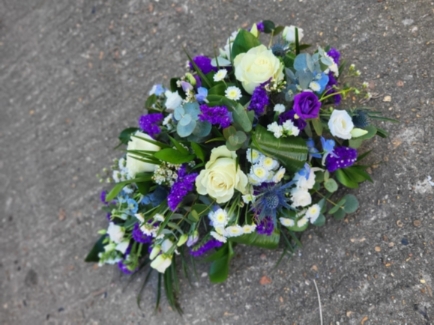 Mixed flowers teardrop to include white roses and purple limonium, lisantuh, delphinims, thisle and eucalyptus by Blooms and Candy Florist from Bromley