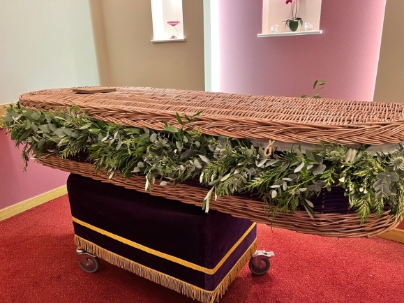 Wild looking funeral garland around coffin installed by local florist in Bromley