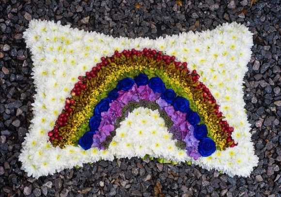funeral rainbow pillow tribute arranged by florist in Bromley
