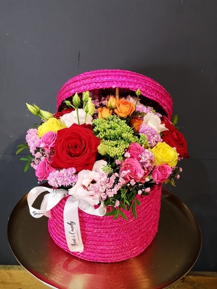 Hot pink hat box with vibrant flowers arranged by florist in Hayes, Bromley