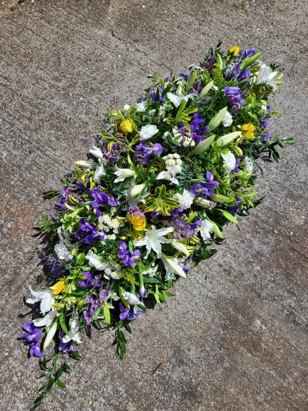 Lily and iris coffin spray made by florist in Bromley, UK