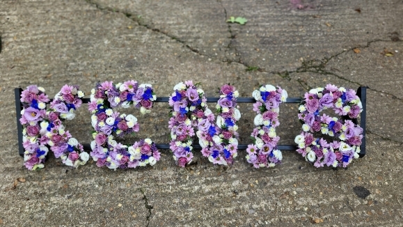 Lilac mixed funeral letters by Blooms and Candy Florist from Hayes, Kent. 