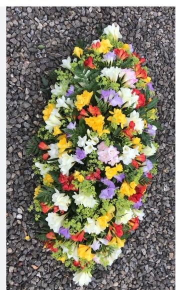 Coffin spray made of scented freesias by florist in Hayes, Bromley, Kent