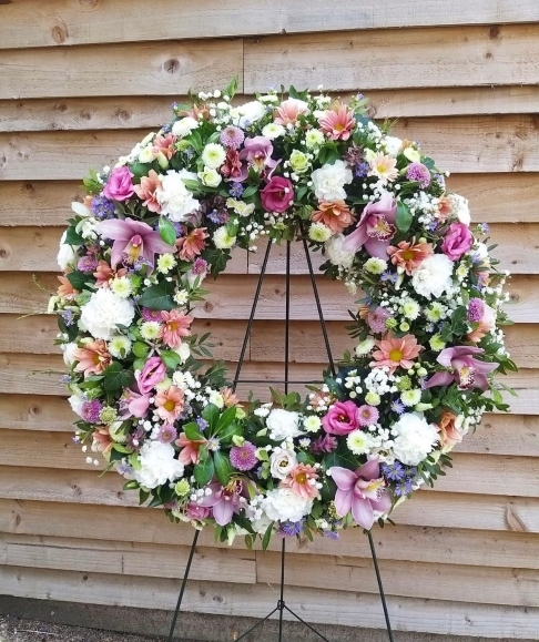 Stunning multicoloured funeral wreath to include cymbidium orchids.  easel included By funeral florist in Bromley 